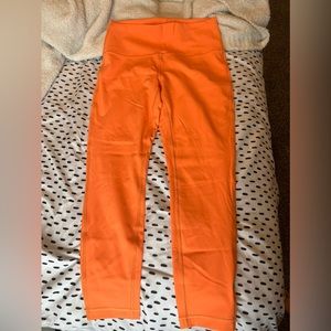 Orange cropped LuLulemon leggings.